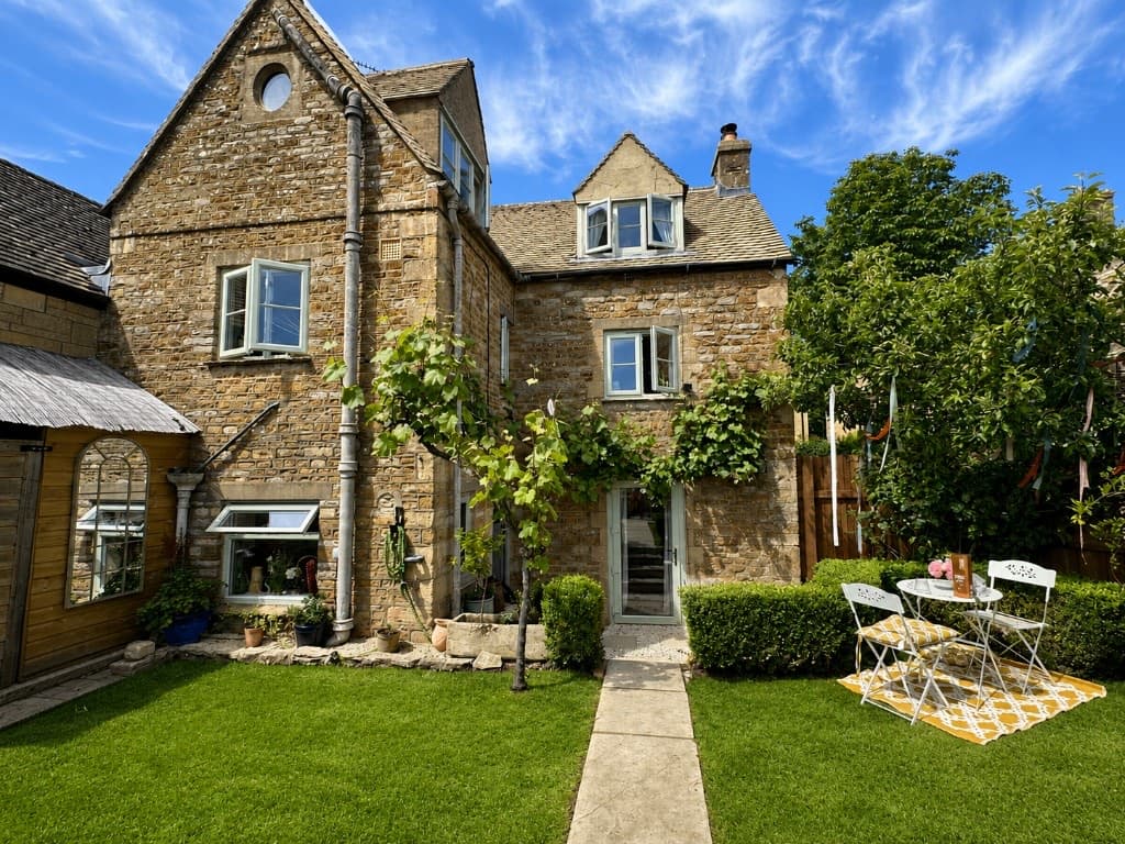 Hill View stone cottage with garden path and outdoor seating