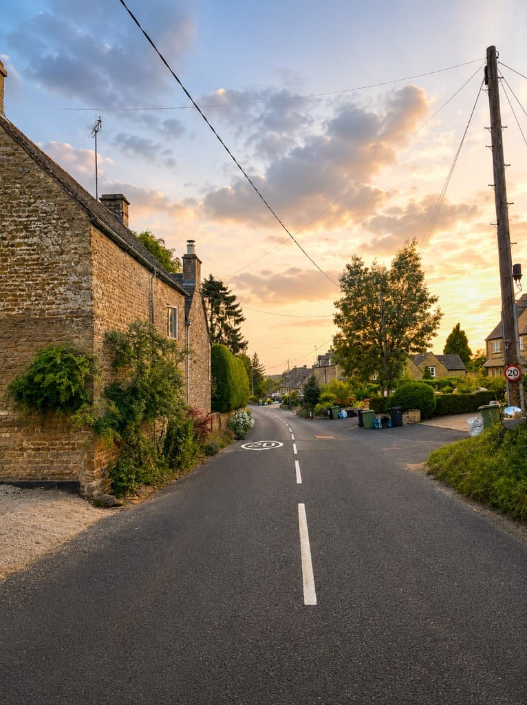 Quiet village lane in Little Rissington at sunset